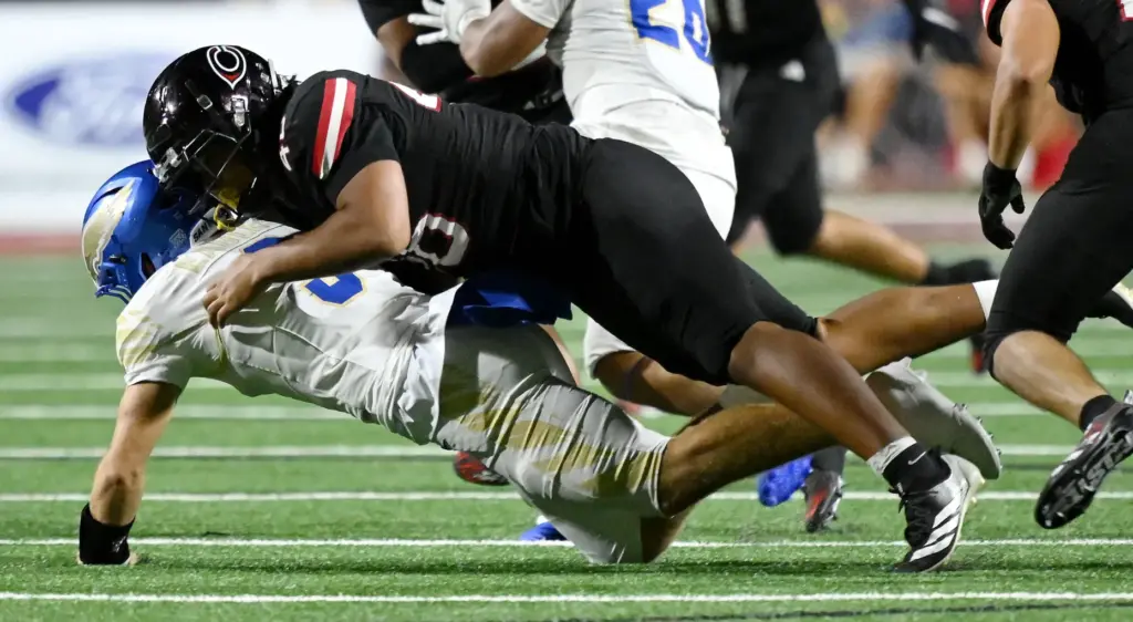 Centennial defensive lineman Chris Anderson (46) sacks Santa Margarita quarterback...