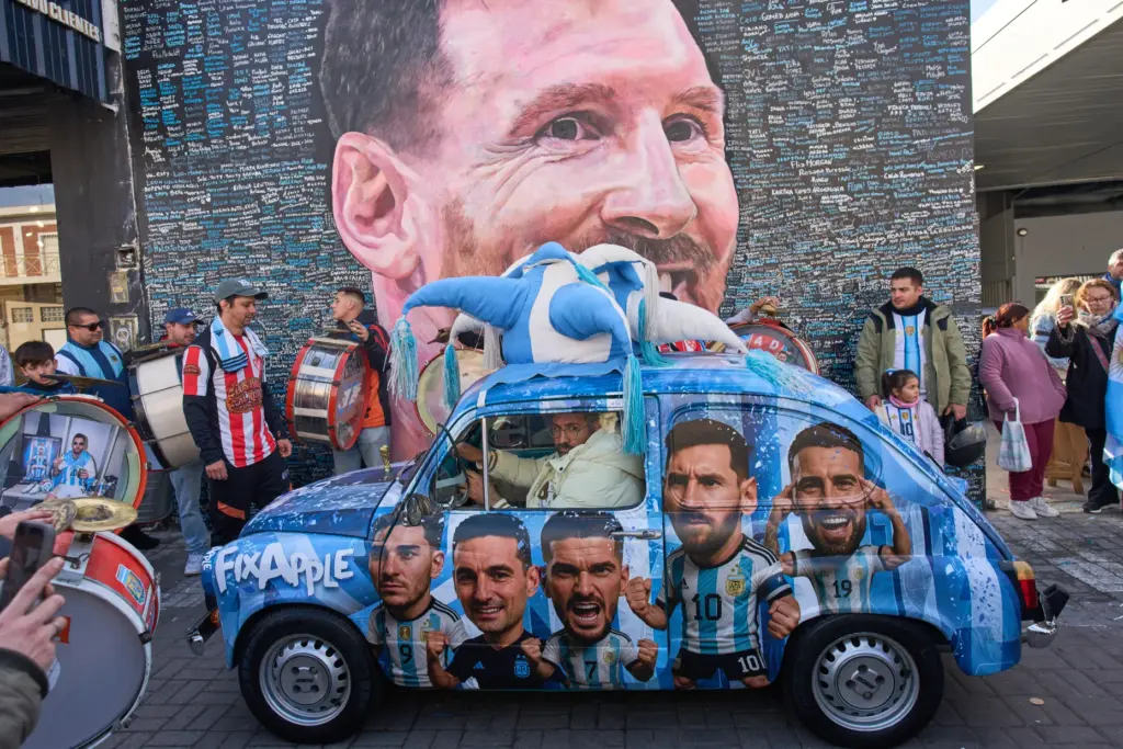 FILE – People sing happy birthday to Lionel Messi at...