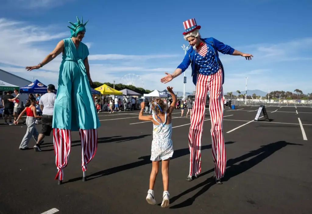 Sophia Carver, 6, of Mission Viejo gives a high five...
