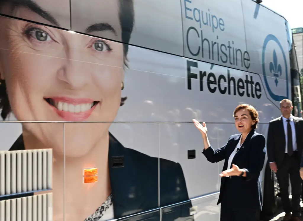 Coalition Avenir Quebec Leader Christine Frechette poses as she walks by her campaign bus.