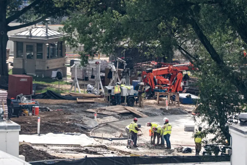 Workers use a jackhammer on the helipad on the South...