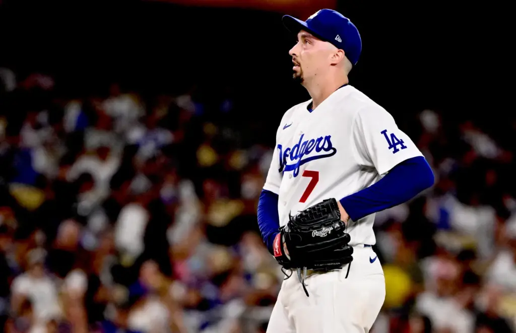 Dodgers starting pitcher Blake Snell looks up after giving up...