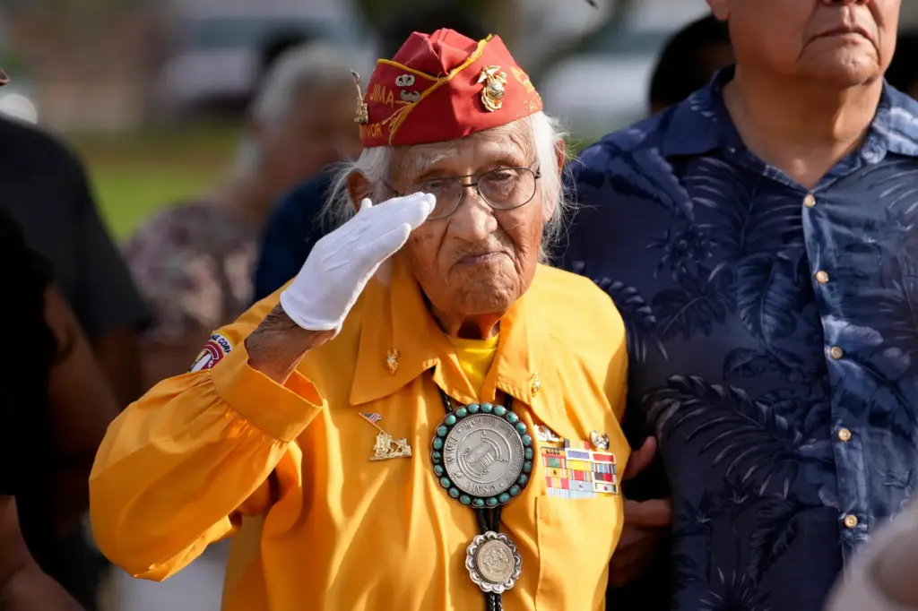 Navajo Code Talker Thomas Begay salutes during the national anthem...