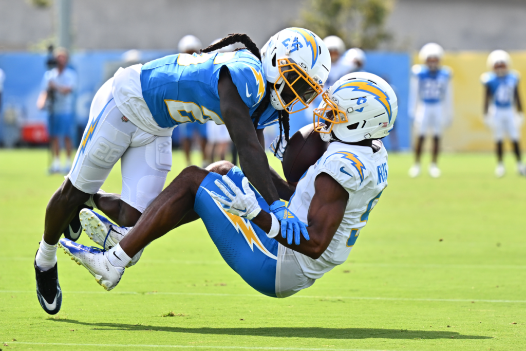 Chargers wide receiver Tre Harris, right, makes a catch while...