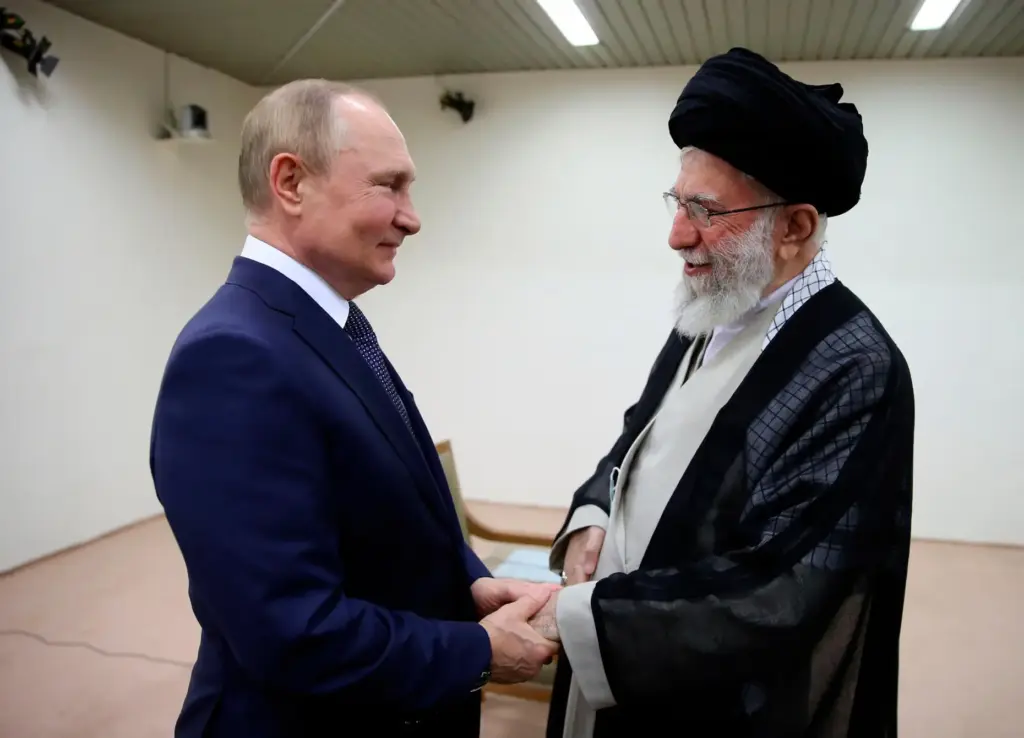Iranian Supreme Leader Ayatollah Ali Khamenei and Russian President Vladimir Putin greet each other.