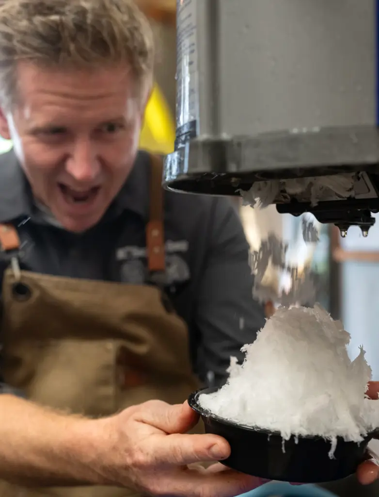 The Shore chef and owner Michael Campbell prepares shaved ice...