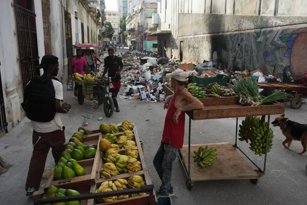 A man sells fruit during a power outage in Havana,...
