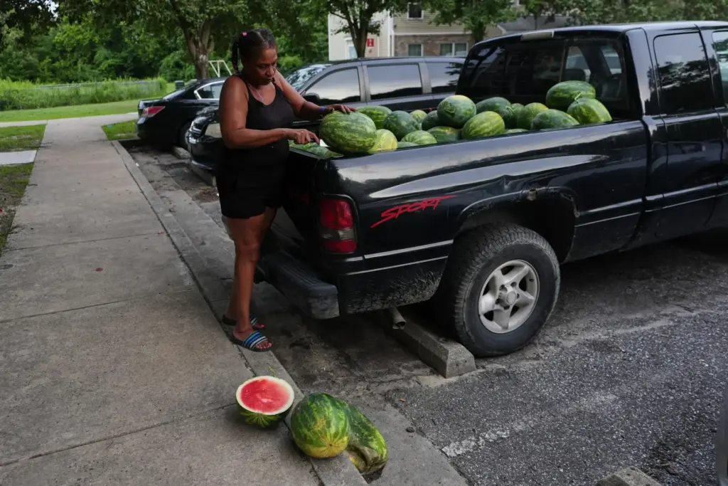 Rhonda Bracy cuts watermelons outside her home in Salisbury, Maryland.