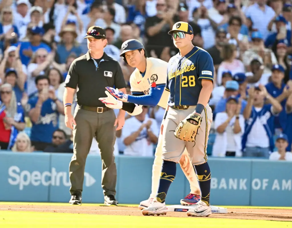Shohei Ohtani of the Dodgers reacts after hitting a RBI...