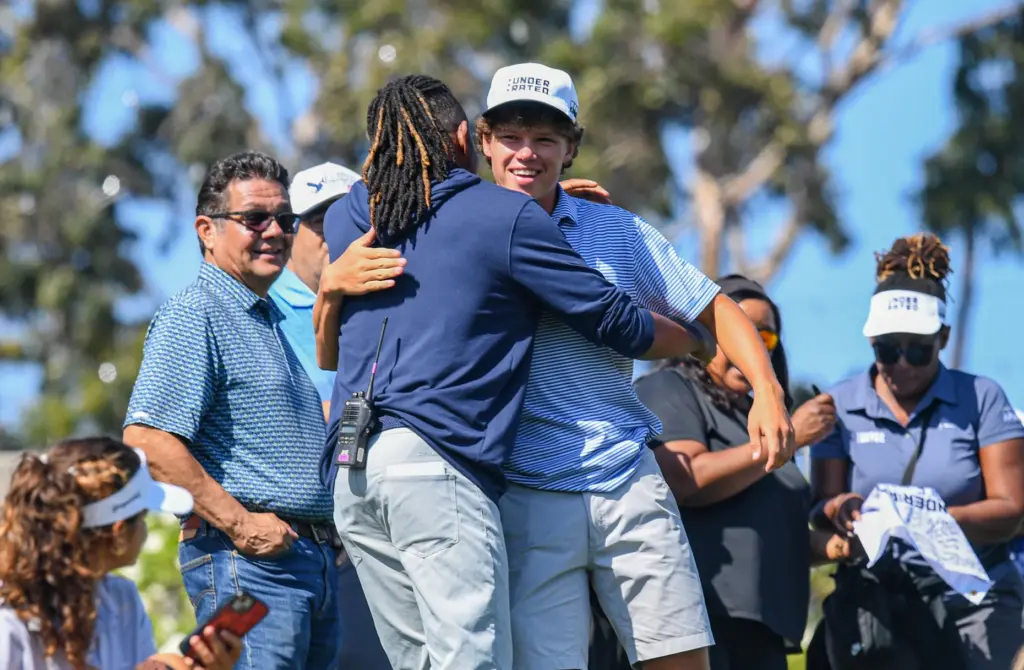 Lucas Gimenez hugs someone after winning the UNDERRATED Golf Tour...