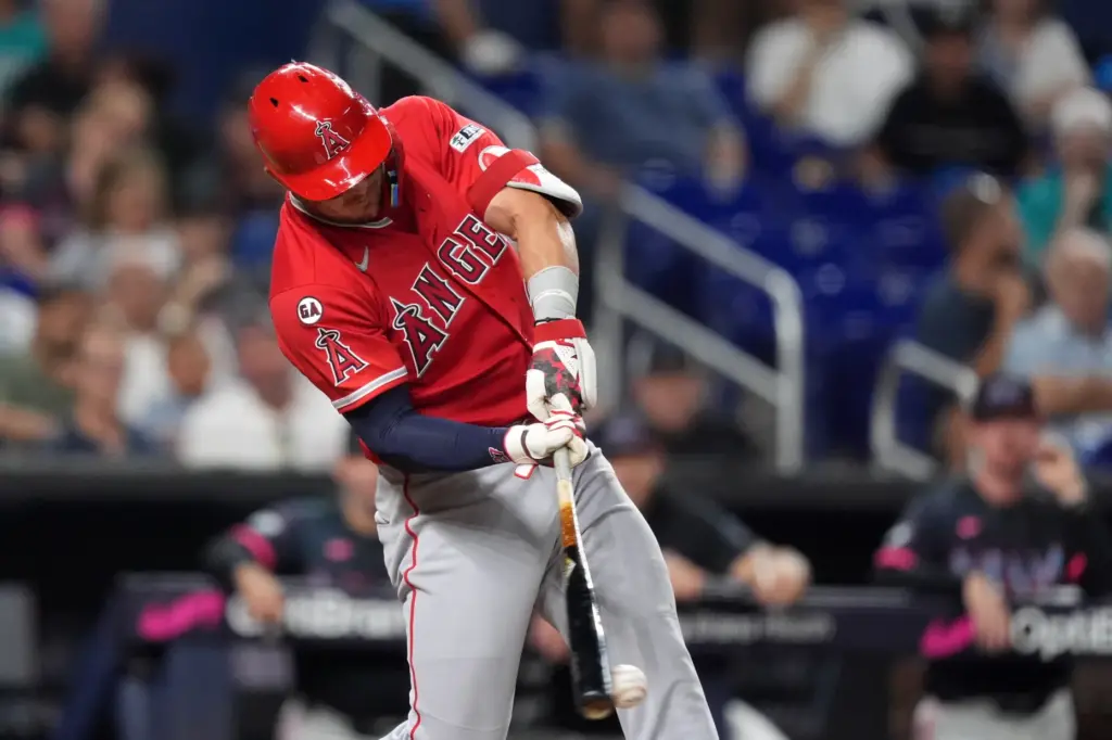 Angels star Mike Trout hits a pitch to reach first...