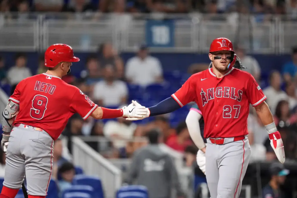 Angels star Mike Trout, right, celebrates with teammate Zach Neto...