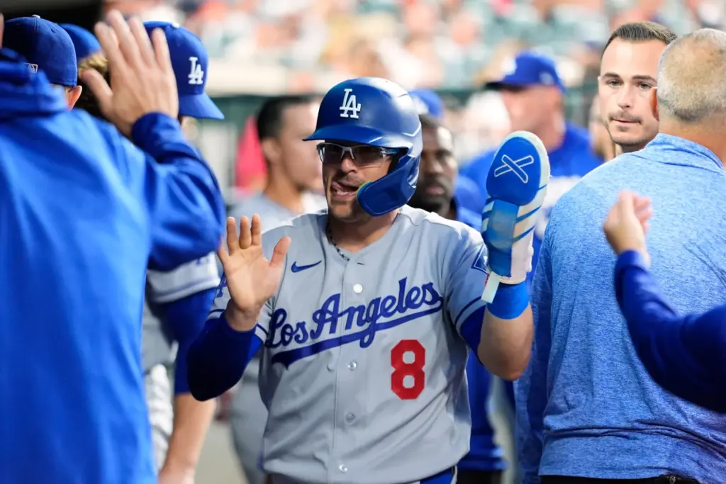 The Dodgers’ Kike HernÃ¡ndez celebrates in the dugout after scoring...