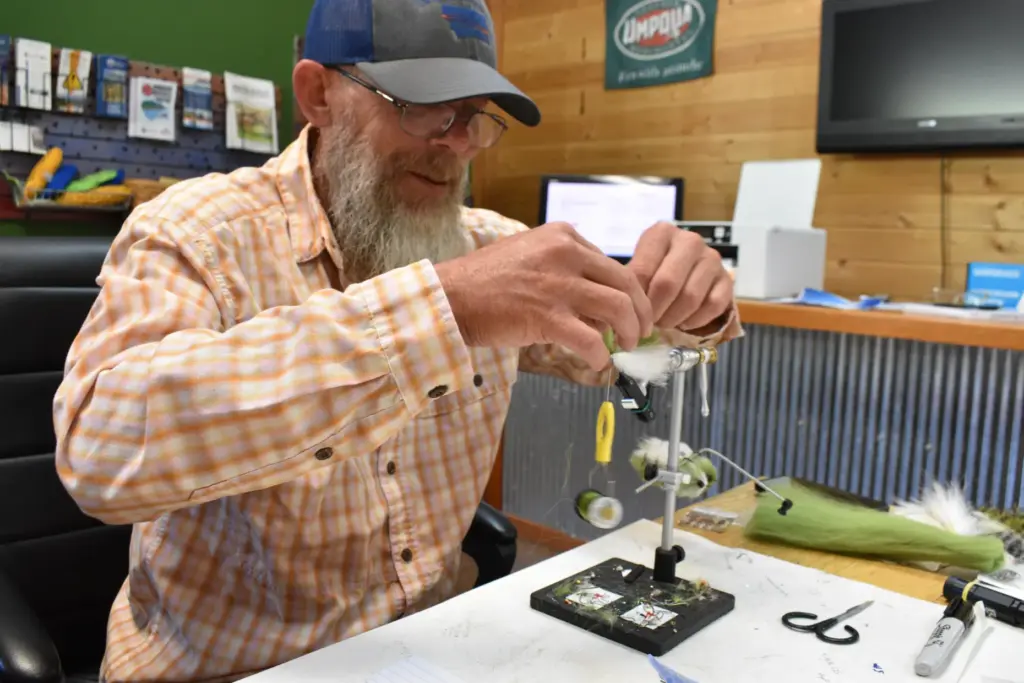 Rich Ridgeway is seen tying a lure at Sweetwater Fly...