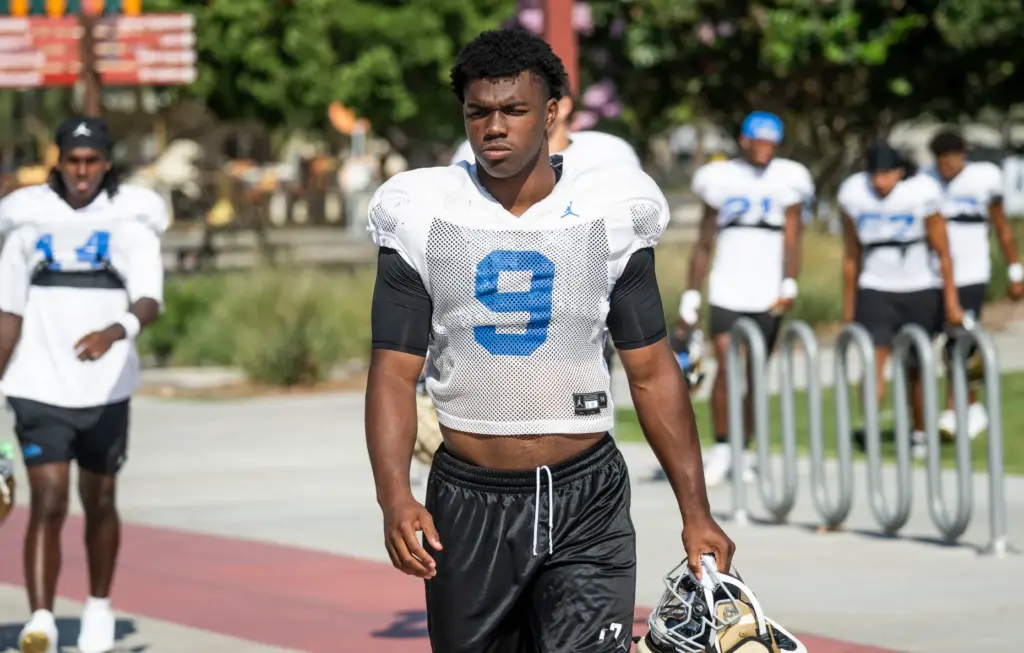 UCLA linebacker Jalen Woods walks to the field for the...