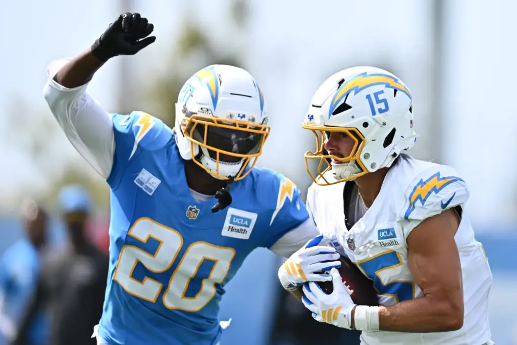 Chargers wide receiver Ladd McConkey, right, makes a catch while...