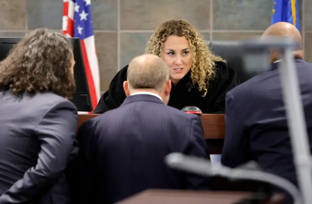 District Court Judge Carli Kierny confers with attorneys.