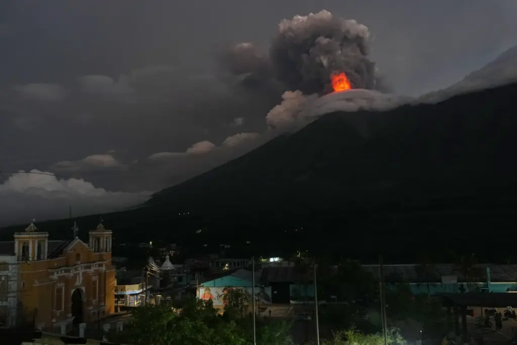 Lava flows and clouds of ash out of the crater...