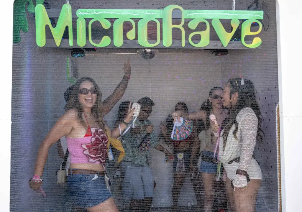 Friends dance together in the MicroRave popup at the Daisy...