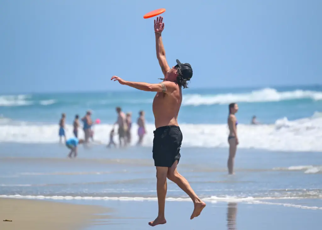 Maurice Sandoval plays frisbee with his girlfriend, Veronica Rodriguez, on...