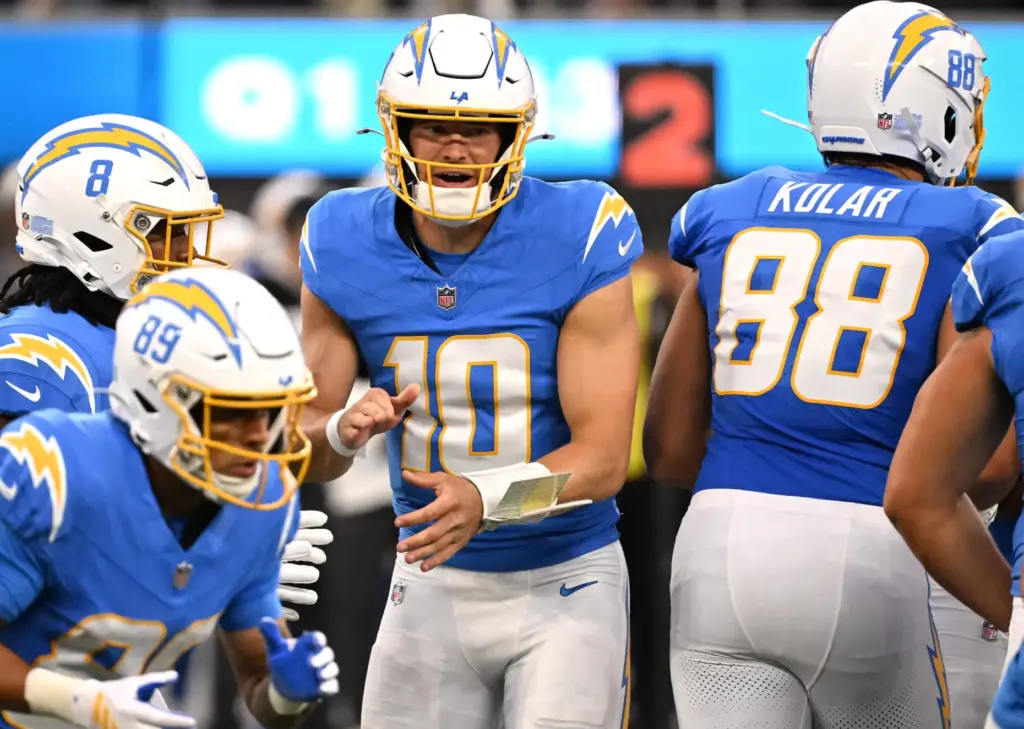Chargers quarterback Justin Herbert (10) breaks the huddle with his...