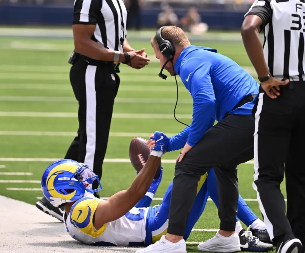 Rams head coach Sean McVay helps up wide receiver Tyler...