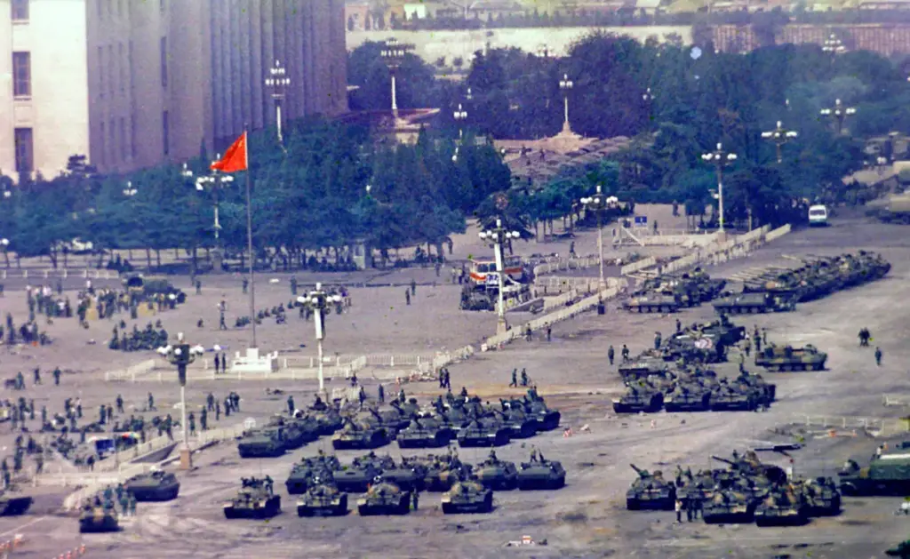 FILE – Chinese troops and tanks gather near Tiananmen Square...