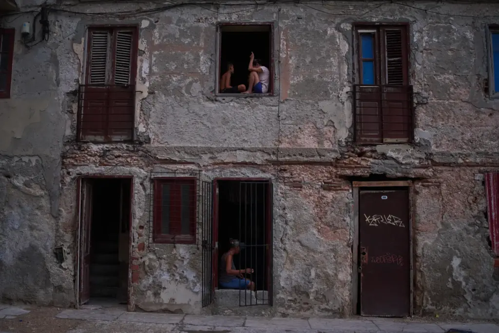 People catch the cool air from the street at their...