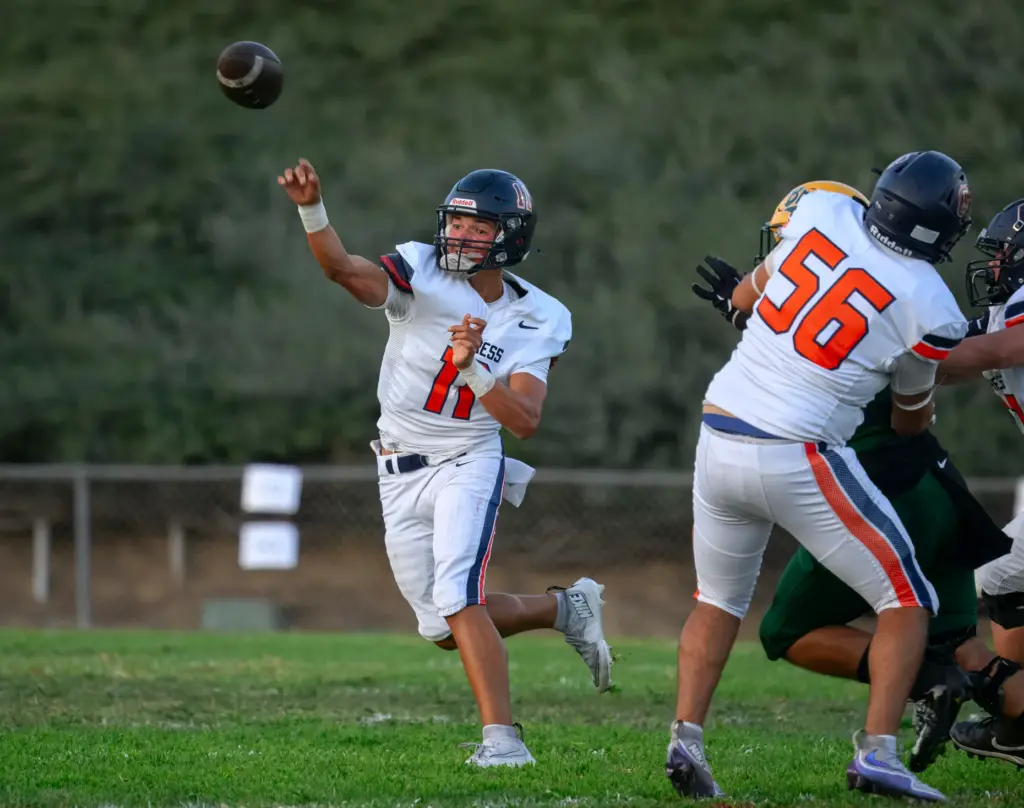 Cypress quarterback Justin Hall fires a pass against Brea Olinda...