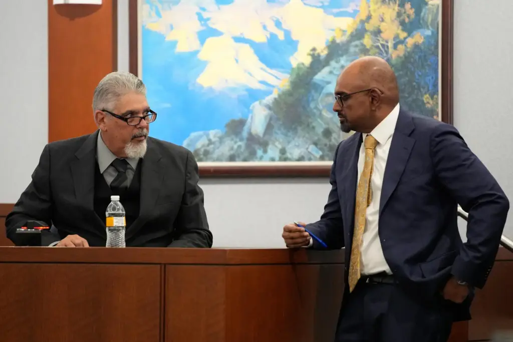 Robert Ladd testifies as Chief Deputy District Attorney Binu Palal listens.