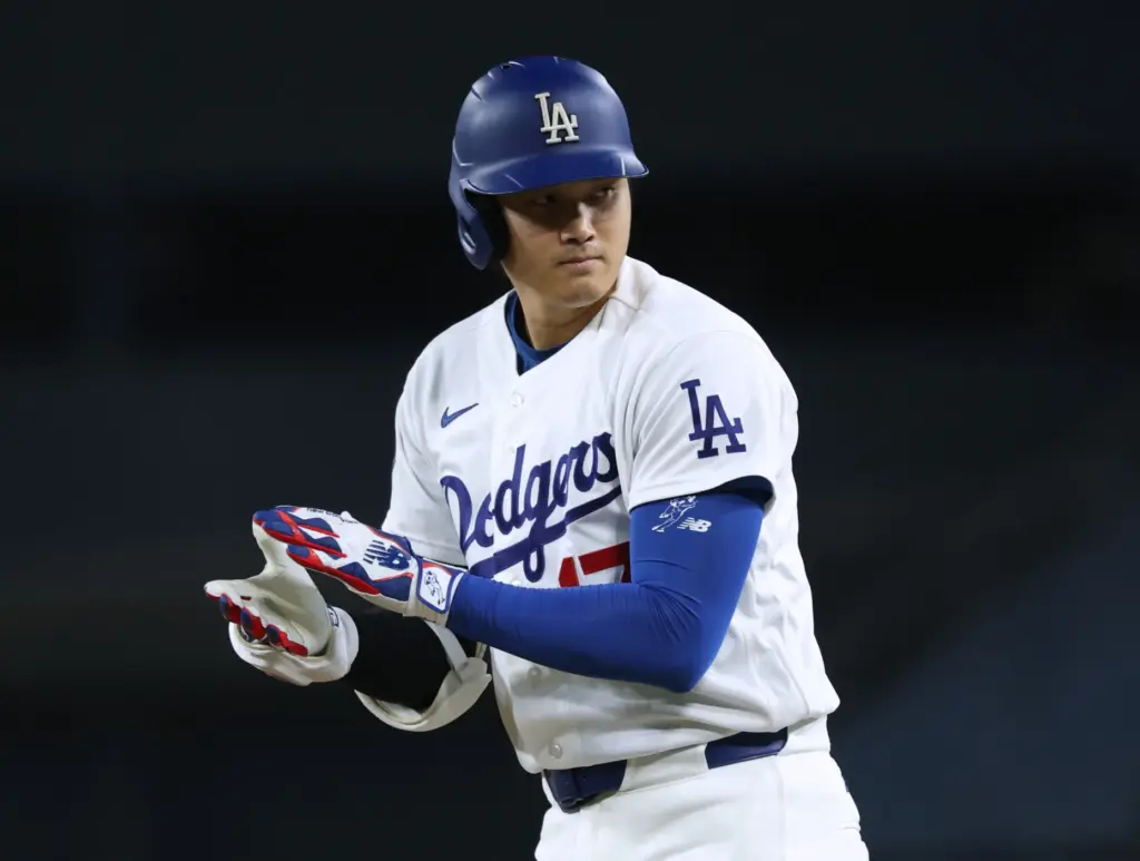 Dodgers star Shohei Ohtani celebrates at first base after his...