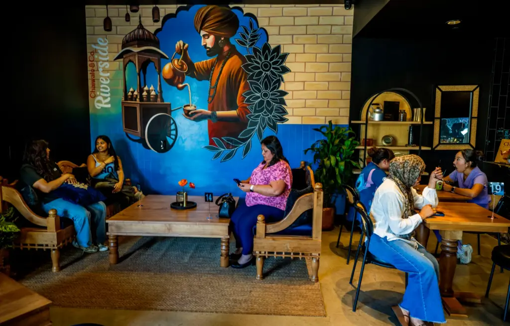 Customers enjoy conversation over chai and food at Chaiwale &...