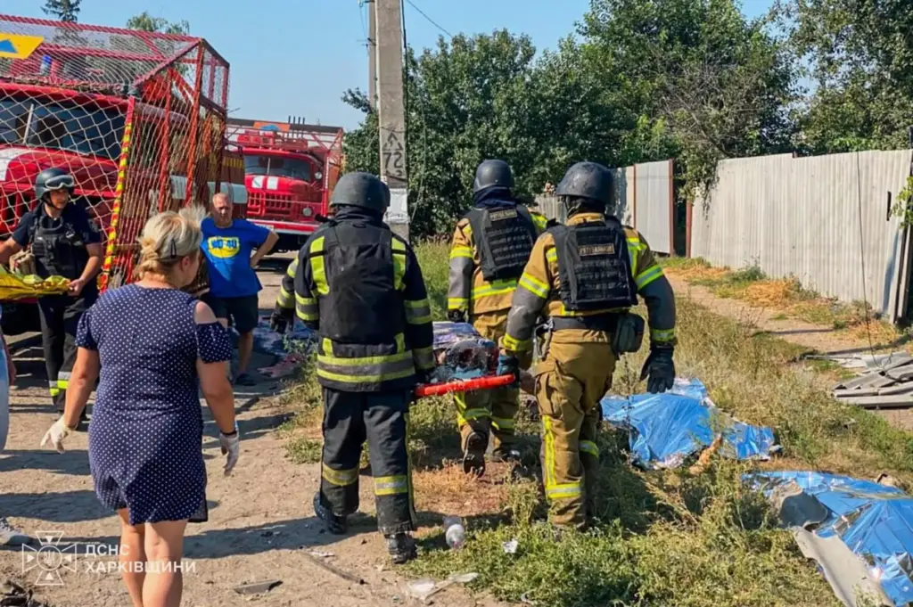 Rescuers carry a body that they removed from under the rubble of a house.