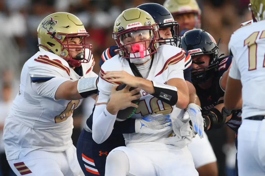Oaks Christianâs Niko Bladow (10) is sacked by Chaminadeâs Brayden...