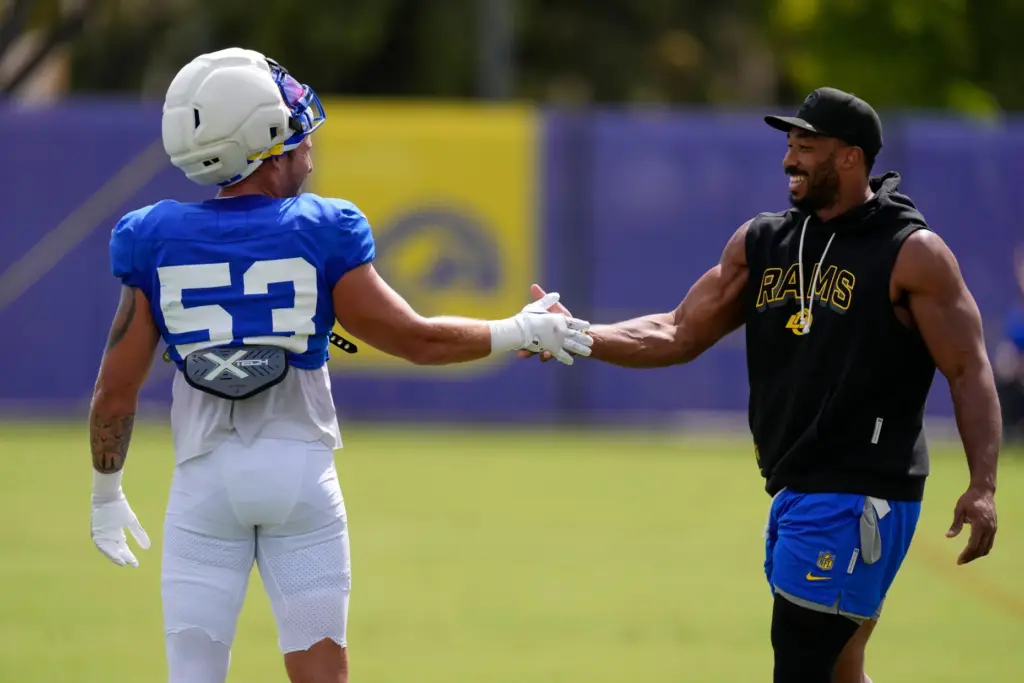 Rams linebacker Nate Landman, left, shakes hands with defensive end...