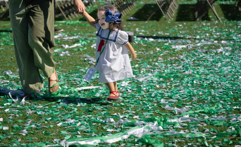 Gracie Johnson walks through confetti with her daughter Henley on...