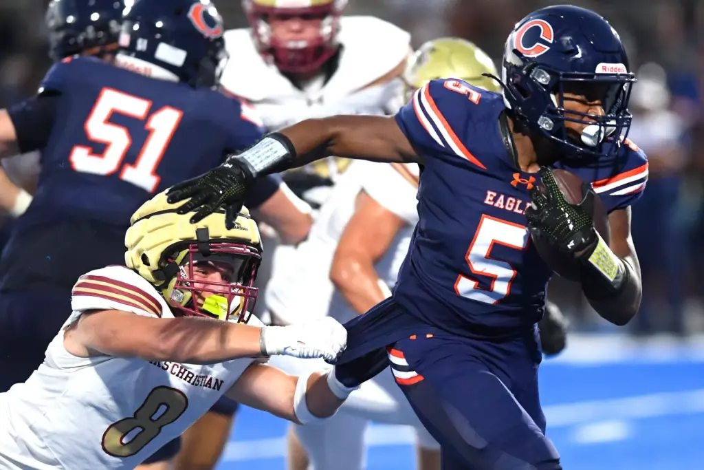 Oaks Chritianâs Hayden Kennington (8) tries to bring down Chaminadeâs...