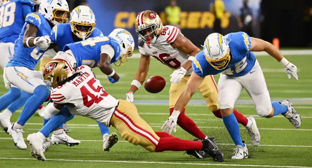 Chargers wide receiver Devonte Ross (24) fumbles the ball during...
