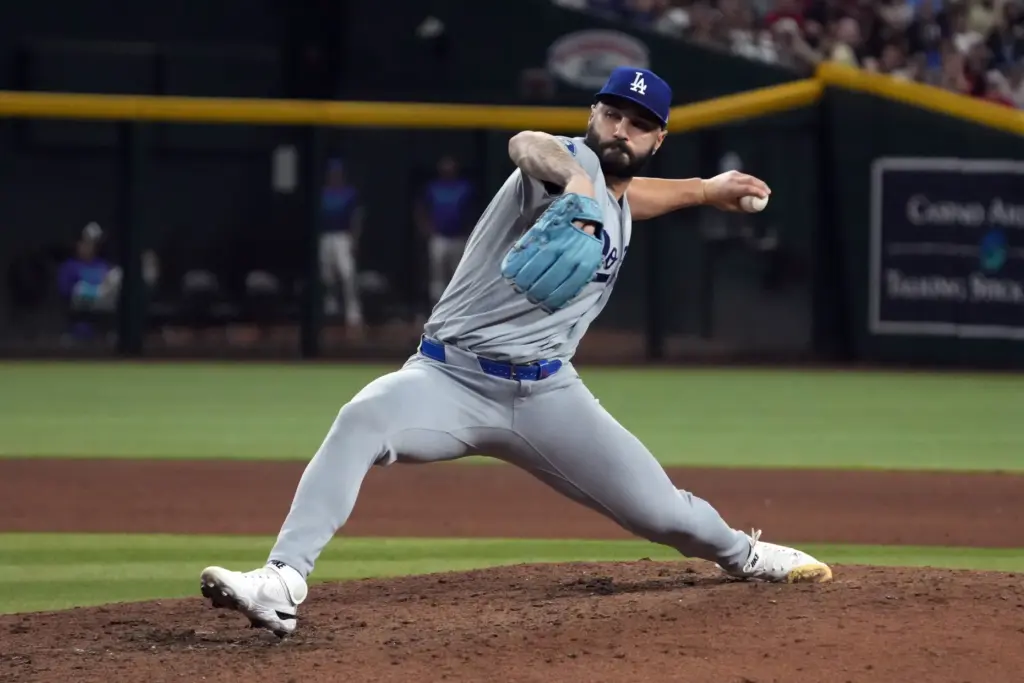 Dodgers relief pitcher Tanner Scott throws to the plate during...