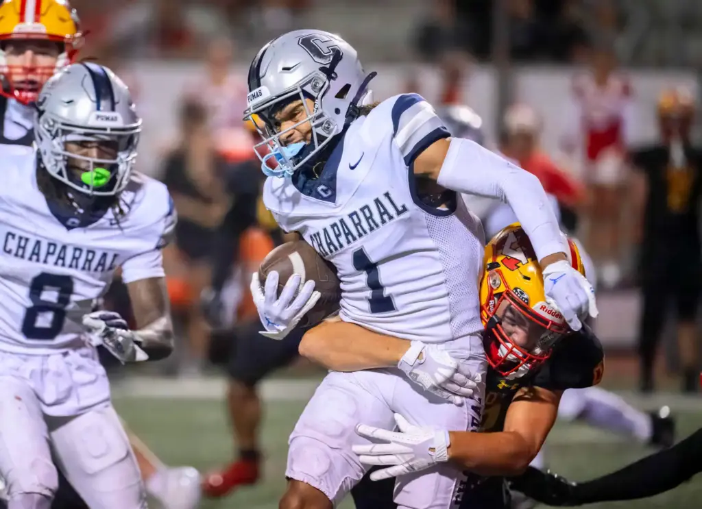 Chaparral wide receiver Michael Kiko Farinas is brought down by...