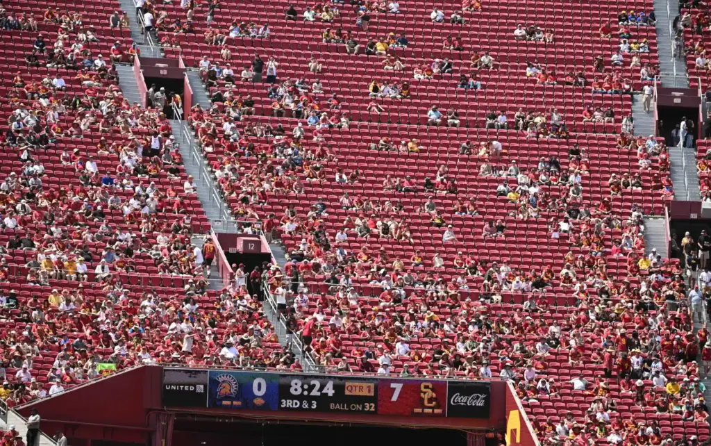 Football fans look on in the first half of a...