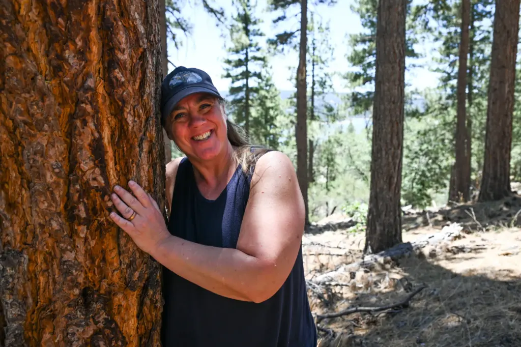 Jenny Voisard, with Friends of Big Bear Valley, hugs one...