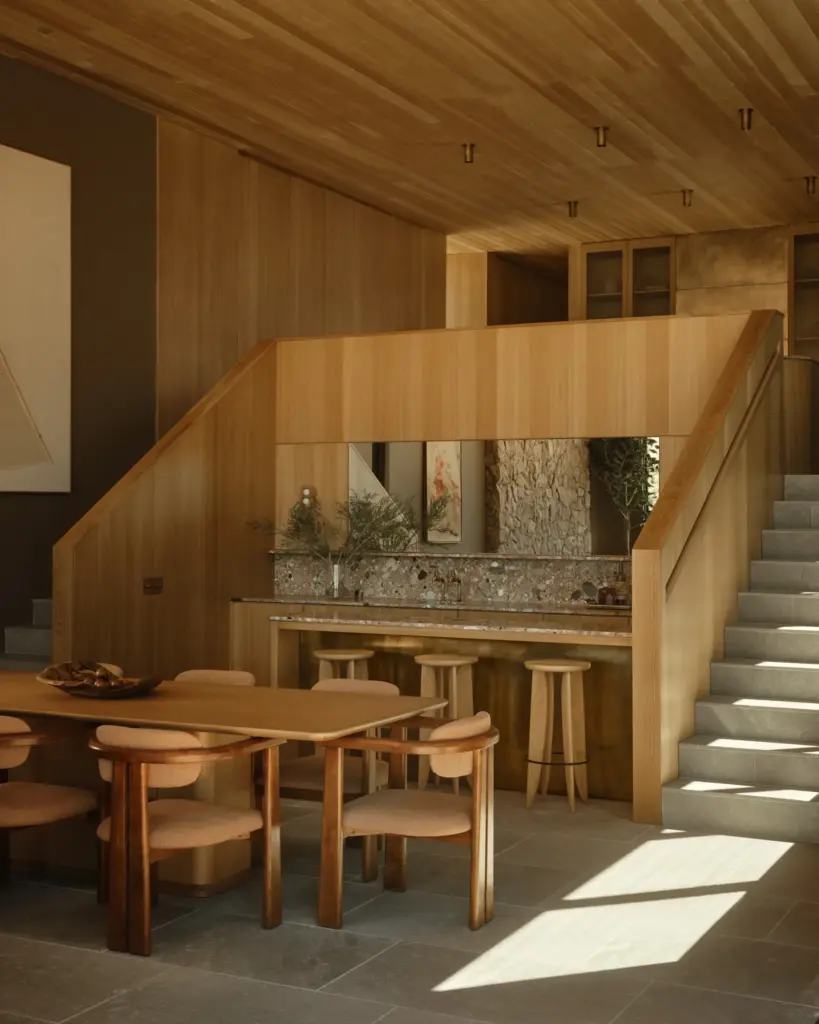 Two stairways lead down to an entertainment level, featuring a...