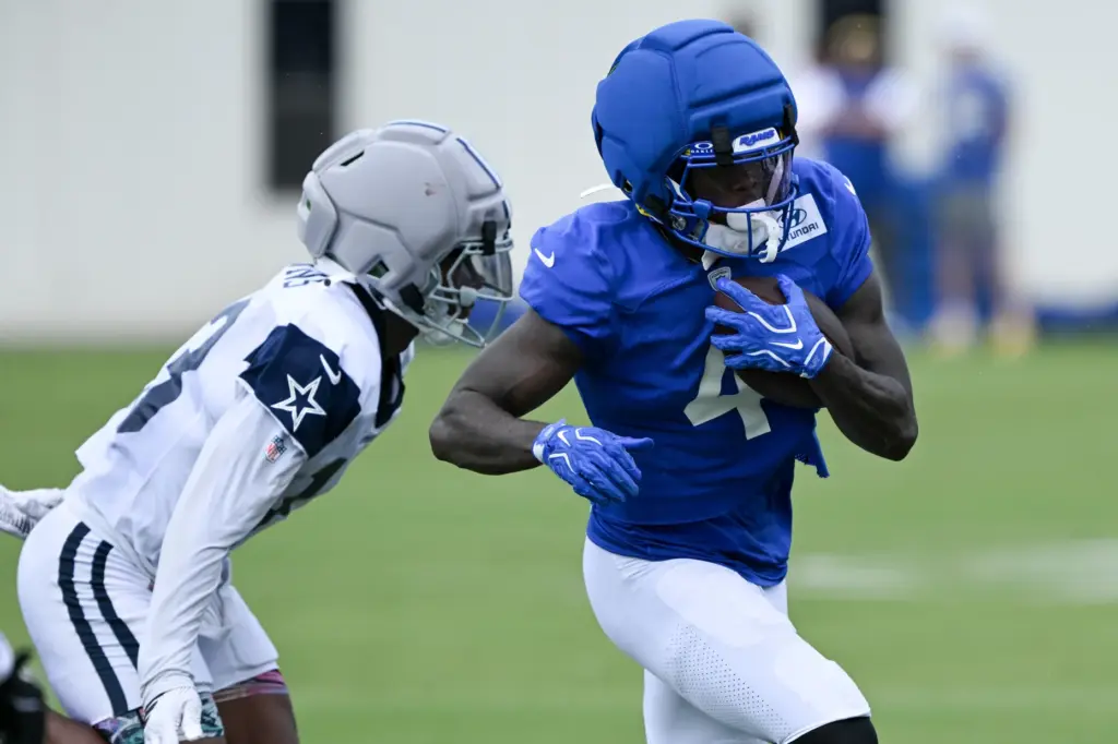 Rams wide receiver Konata Mumpfield, right, and Dallas Cowboys rookie...