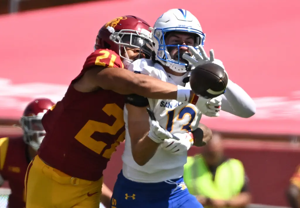 Cornerback RJ Sermons (21) of the USC Trojans knocks away...