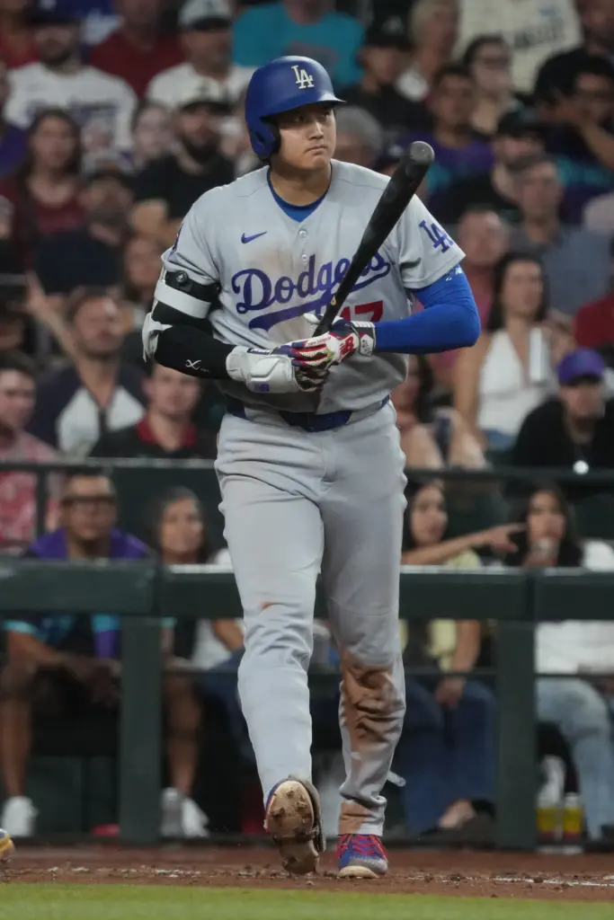 Dodgers star Shohei Ohtani walks back to the dugout after...