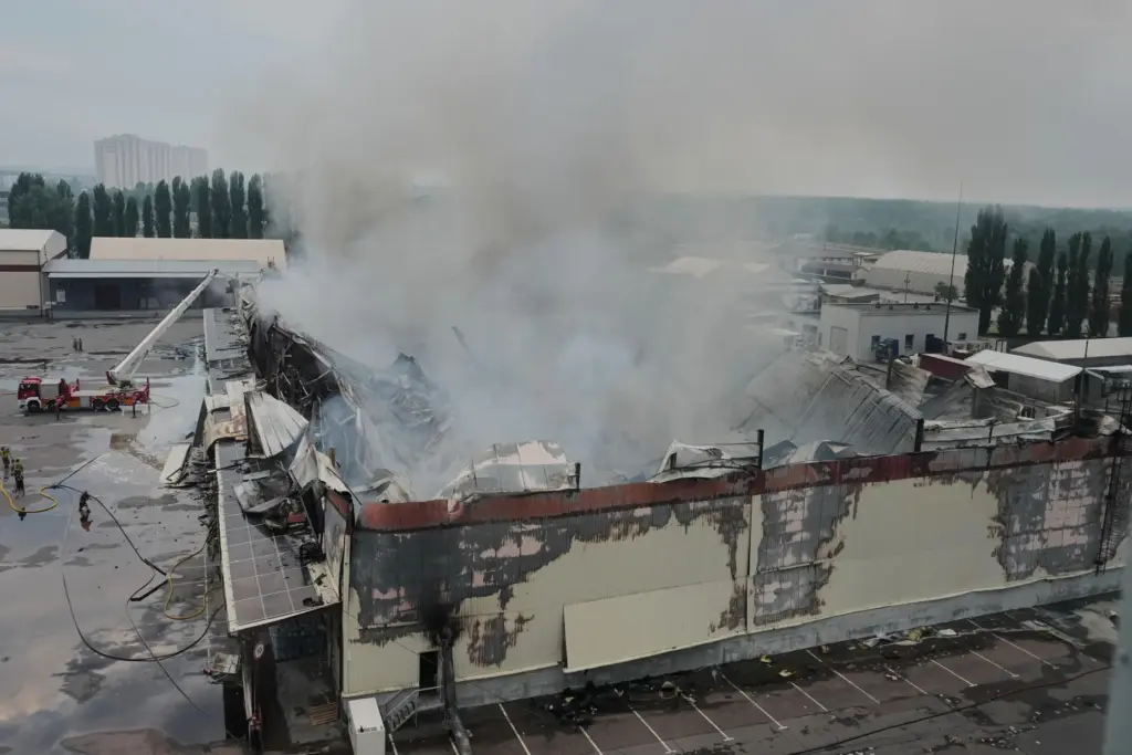 Firefighters put out a fire after Russian missiles hit a food warehouse near Kyiv, Ukraine.