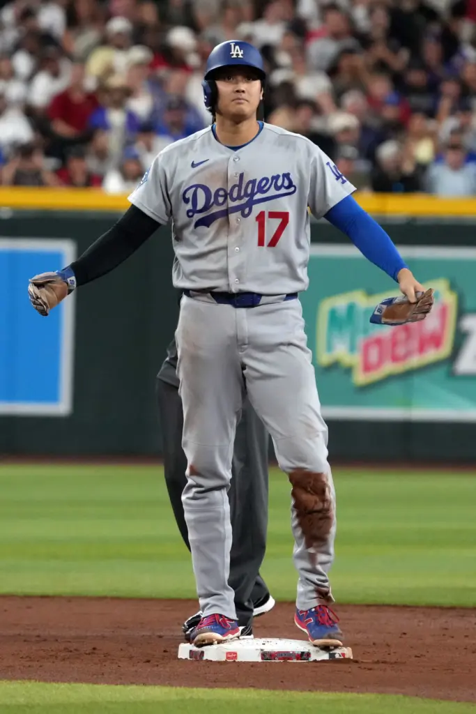 Dodgers star Shohei Ohtani looks to his dugout after getting...