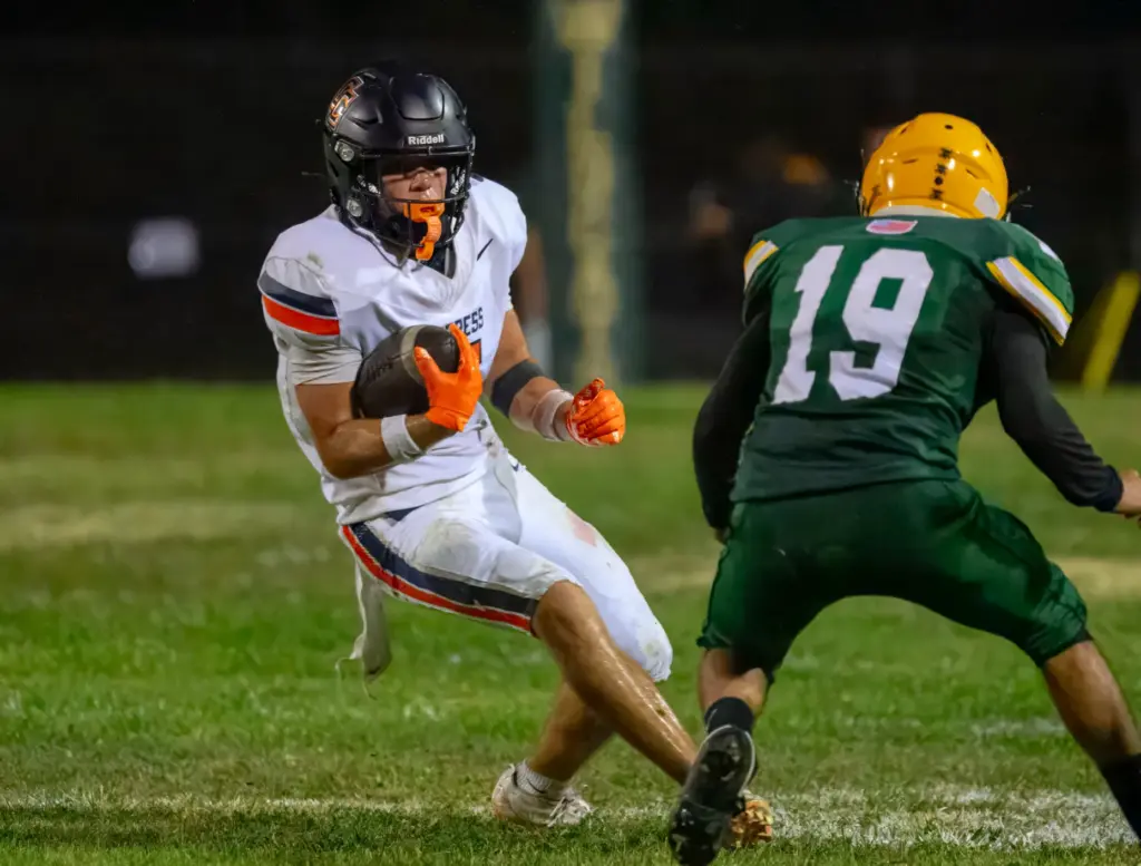 Cypress running back Louden Aljian, left, tries to get by...