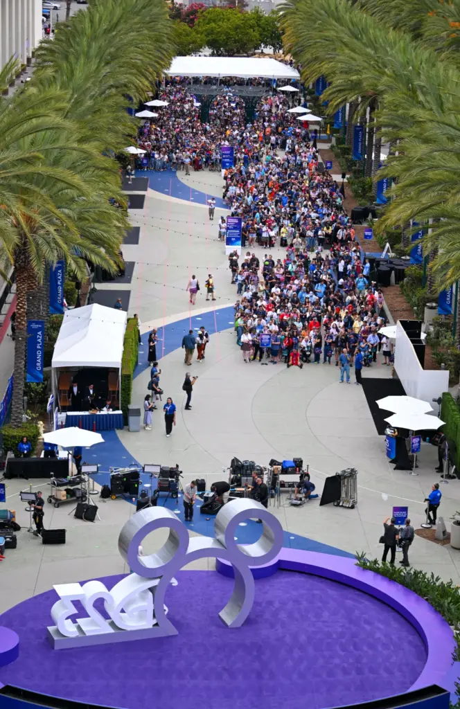People wait to enter the D23 Disney fan expo on...